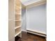 Walk-in closet featuring custom built-in shelving and organization system plus dark wood floor at 3226 Cordoba Ranch Blvd, Lutz, FL 33559