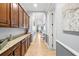 Hallway with built-in cabinets, tiled floors, elegant decor leads to a spacious living area at 3226 Cordoba Ranch Blvd, Lutz, FL 33559