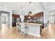 Spacious kitchen featuring an island, granite countertops, stainless steel appliances, and dark wood cabinets at 3226 Cordoba Ranch Blvd, Lutz, FL 33559