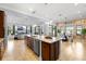 Open concept kitchen featuring stainless appliances, granite counters, a large island, and adjacent living areas at 3226 Cordoba Ranch Blvd, Lutz, FL 33559