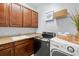 Laundry room with sink, granite countertops, upper cabinets, and modern washer and dryer at 3226 Cordoba Ranch Blvd, Lutz, FL 33559