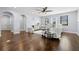 Bright living room features hardwood floors, a ceiling fan, and multiple windows offering ample natural light at 3226 Cordoba Ranch Blvd, Lutz, FL 33559