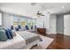Bright main bedroom with hardwood floors, recessed lighting, and multiple windows with neighborhood views at 3226 Cordoba Ranch Blvd, Lutz, FL 33559
