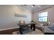 Cozy home office featuring coffered ceilings, a large window, and a comfortable seating area at 3226 Cordoba Ranch Blvd, Lutz, FL 33559