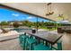 Open patio showcases a pool, outdoor kitchen, dining table, and green backyard at 3226 Cordoba Ranch Blvd, Lutz, FL 33559