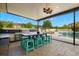 This covered patio area includes a grilling space, dining area, and backyard pool at 3226 Cordoba Ranch Blvd, Lutz, FL 33559