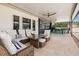 Covered patio features a seating area with a dining table, outdoor bar, and tile flooring at 3226 Cordoba Ranch Blvd, Lutz, FL 33559