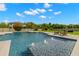 Backyard pool with fountains, lounge chairs, and meticulous landscaping at 3226 Cordoba Ranch Blvd, Lutz, FL 33559