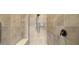 Tiled walk-in shower featuring a showerhead, a handheld shower, and a bench at 3226 Cordoba Ranch Blvd, Lutz, FL 33559