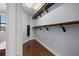 Walk-in closet with wood floors, ample shelving, and an organization system for clothing and storage at 3226 Cordoba Ranch Blvd, Lutz, FL 33559