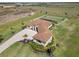 A lovely aerial view of the property with a beautiful landscape, red tiled roof, and long driveway at 3487 Recurve Cir, Sarasota, FL 34240