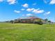 Expansive backyard showcasing the screened pool and patio area, complemented by a well-maintained lawn at 3487 Recurve Cir, Sarasota, FL 34240
