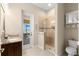 Bright bathroom featuring a glass-enclosed shower, granite countertop vanity, and access to the outdoor pool area at 3487 Recurve Cir, Sarasota, FL 34240