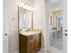 Bathroom featuring granite vanity, modern lighting, and a door leading to the outdoor living space and pool at 3487 Recurve Cir, Sarasota, FL 34240