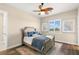 Comfortable bedroom featuring a cozy bed, stylish ceiling fan, neutral paint, and bright window for natural light at 3487 Recurve Cir, Sarasota, FL 34240