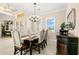 Elegant dining room features a chandelier and seating for six, perfect for entertaining at 3487 Recurve Cir, Sarasota, FL 34240