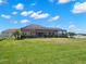 Beautiful exterior showcasing the property's lush green lawn and the screened outdoor living space at 3487 Recurve Cir, Sarasota, FL 34240