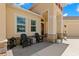 Cozy front porch with stone accents, outdoor seating, and a view of the well-maintained yard and driveway at 3487 Recurve Cir, Sarasota, FL 34240