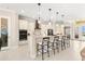 Open kitchen featuring an eat-in island, modern appliances and sleek cabinetry at 3487 Recurve Cir, Sarasota, FL 34240