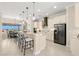 Open kitchen with stainless steel appliances and a breakfast bar with seating at 3487 Recurve Cir, Sarasota, FL 34240