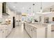 Bright open kitchen features large island with stainless steel appliances and modern cabinetry at 3487 Recurve Cir, Sarasota, FL 34240