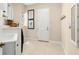 Functional laundry room with white cabinetry, a sink, a washer, and a dryer for convenient household chores at 3487 Recurve Cir, Sarasota, FL 34240