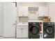 Efficient laundry room featuring modern appliances, ample counter space, storage cabinets, and a convenient utility sink at 3487 Recurve Cir, Sarasota, FL 34240