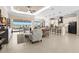 Open-concept living area flows into a modern kitchen with bar seating and access to the outdoor lanai at 3487 Recurve Cir, Sarasota, FL 34240