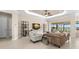 Bright and airy living room with neutral tones, tile flooring, and a seamless transition to the outdoor space at 3487 Recurve Cir, Sarasota, FL 34240