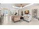Bright and open living room with tile floors, connecting to the dining area, perfect for entertaining guests at 3487 Recurve Cir, Sarasota, FL 34240