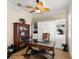 A tidy office with a ceiling fan, built in shelving, and natural light at 3487 Recurve Cir, Sarasota, FL 34240