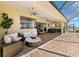 Outdoor seating area on screened lanai with beautiful backyard views at 3487 Recurve Cir, Sarasota, FL 34240