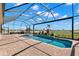 Screened-in pool with brick patio, lush landscaping, and scenic views of the surrounding countryside at 3487 Recurve Cir, Sarasota, FL 34240
