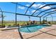 Relaxing pool and spa area with an umbrella-covered table and spacious lounge chairs at 3487 Recurve Cir, Sarasota, FL 34240