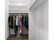 Spacious walk-in closet offering hanging storage solutions with clothing racks and custom white shelving for optimal organization at 3487 Recurve Cir, Sarasota, FL 34240