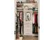 Organized walk-in closet featuring built-in shelving, drawers, a mirror, and hanging rods for ample storage space at 3487 Recurve Cir, Sarasota, FL 34240