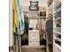 Well-organized walk-in closet with custom shelving, drawers, hanging rods and a mirror at 3487 Recurve Cir, Sarasota, FL 34240