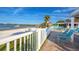 Beautiful beachside patio with white picket fence and lounge seating offering stunning water views at 3735 42Nd S Way # J, St Petersburg, FL 33711