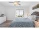 Comfortable bedroom with a decorative headboard, bright window, and neutral color palette at 3735 42Nd S Way # J, St Petersburg, FL 33711