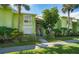 Inviting two-story condo with lush landscaping and a vibrant exterior paint job for a bright tropical feel at 3735 42Nd S Way # J, St Petersburg, FL 33711