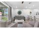 Airy living room with balcony access featuring stylish furniture and a breakfast bar at 3735 42Nd S Way # J, St Petersburg, FL 33711
