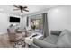 Cozy living room with modern decor, plank wall, comfortable seating, and sliding doors to the outdoor patio at 3735 42Nd S Way # J, St Petersburg, FL 33711