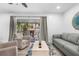 Bright living area with access to screened in balcony, featuring modern furniture at 3735 42Nd S Way # J, St Petersburg, FL 33711