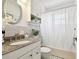 Fresh bathroom featuring a granite countertop, white cabinets, and a combined shower and tub at 3818 W San Miguel St, Tampa, FL 33629