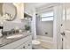Bright bathroom featuring a granite countertop, white cabinets, and a combined shower and tub at 3818 W San Miguel St, Tampa, FL 33629