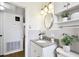 Clean bathroom featuring a granite countertop, white cabinets, and modern fixtures at 3818 W San Miguel St, Tampa, FL 33629