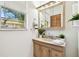 Well-lit bathroom showcasing a vanity with marble countertop and a window with a view at 3818 W San Miguel St, Tampa, FL 33629
