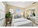 Charming bedroom featuring light colored walls, parquet floors, a sunny window, and modern decor at 3818 W San Miguel St, Tampa, FL 33629