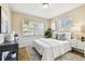 Inviting bedroom featuring white walls, parquet floors, a sunny window, and modern decor at 3818 W San Miguel St, Tampa, FL 33629