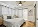 Airy bedroom featuring parquet floors, neutral colors, a ceiling fan, and an ensuite bathroom at 3818 W San Miguel St, Tampa, FL 33629